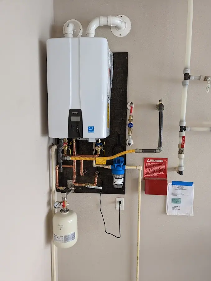 Professional plumber installing copper piping in a McKinney home